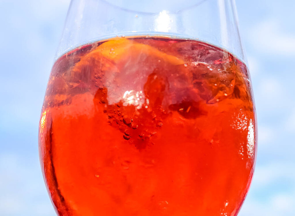 Refreshing orange summer cocktails with cola and ice against a blue sky background.  - Foto, imagen