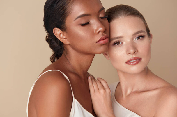 Diversity. Beauty Models Portrait. Different Ethnic Women With Healthy Perfect Skin And Natural Makeup. Caucasian And Mixed Race Female Standing Together Against Beige Background.  - Foto, Bild