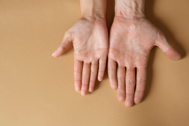 Male and female hands on a brown background close-up. Strong friendship concept - 写真・画像