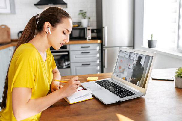 Woman uses laptop for video call indoor - Fotó, kép