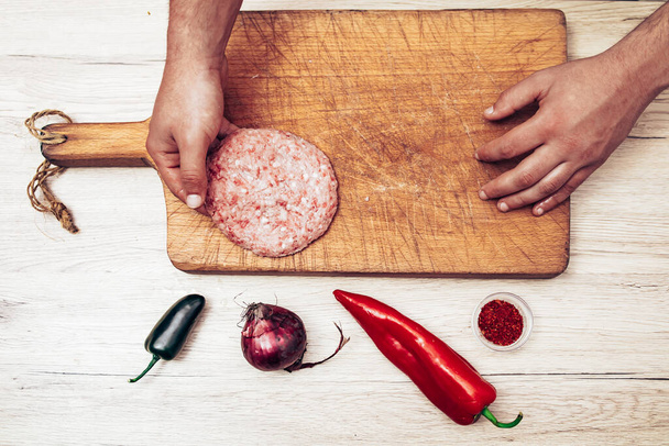 Restaurant chef preparing cevap and burger from minced beef meat. Eastern Europe cuisine. Top view - Фото, изображение