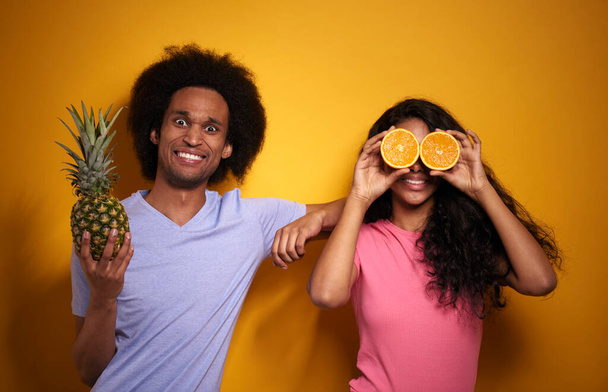 Horizontal image of couple with exotic fruits - Fotó, kép