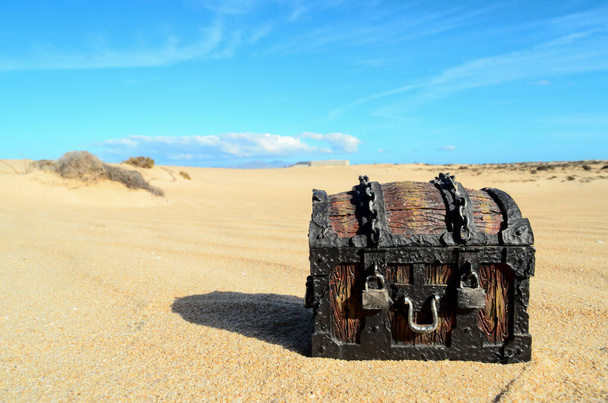 Conceptual Photo Picture of a Treasure Trunk Object in the Dry Desert - Photo, Image