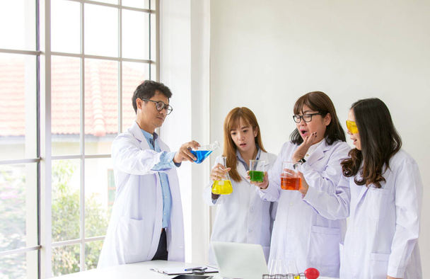 Science Test. Chemist scientific testing quality. Group Scientist working at laboratory. One Man and Three woman at chemistry lab. Asian people. Life scientist researching in laboratory. - Photo, Image