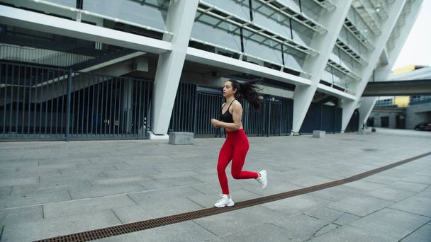 Beautiful woman running on morning training. Young woman jogging outdoor. - Photo, Image