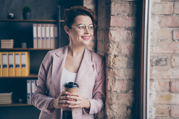 Close-up portrait of her she nice attractive smart clever cheerful dreamy lady looking at window drinking cacao planning day at modern industrial loft brick style interior workplace workstation - Foto, Bild