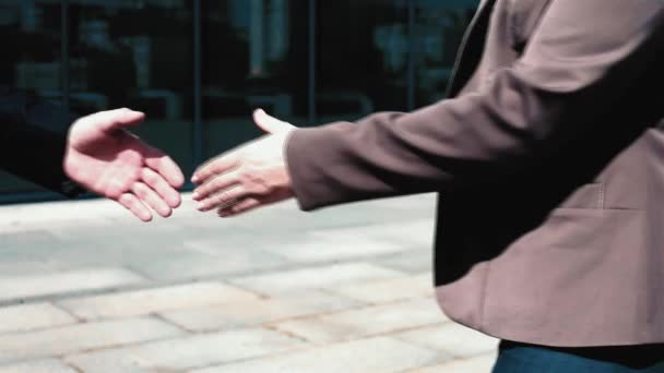 Business people handshake close up man and woman in business clothing. Two colleagues meet outdoors near office building and have a greetings by handshake. Business concept. Prores 422 - Video