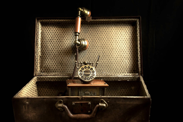 Vintage telephone in old valise - Photo, Image
