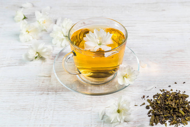 Jasmine tea in a cup on a wooden background. - Photo, Image