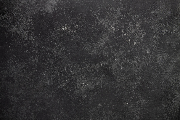 Çimento koyu gri arka plan, sürtünmeler ve siyah lekeler. Grunge biçiminde desenli duvar dokusu. - Fotoğraf, Görsel