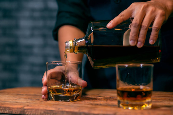 Barman pouring whiskey whiskey glass beautiful night - Zdjęcie, obraz