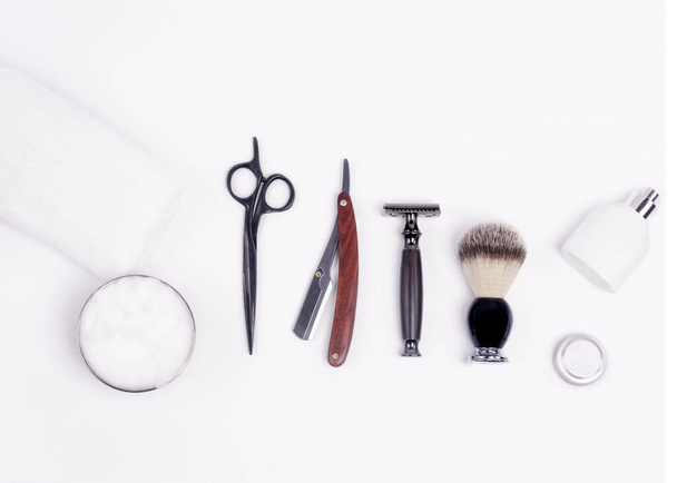 Razors, brush, towels and scissors on a wood background. - Foto, Imagem