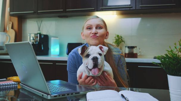 Happy woman with a bulldog looking to the camera and smiling - Fotoğraf, Görsel