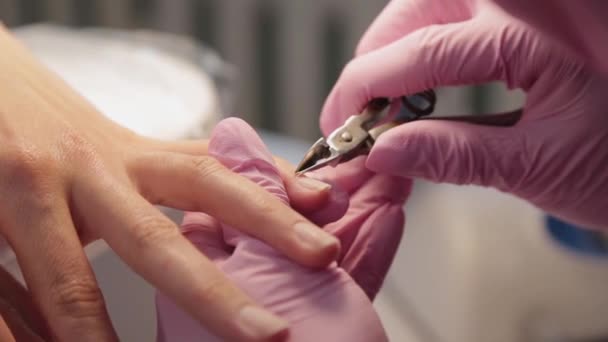 Manicurist removes cuticles with forceps. - Footage, Video