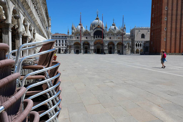 Deserted Saint MArk square called Piazza S.Marco in Venice with only one tourist during the LOCKDOWN caused by the corona virus - Photo, Image