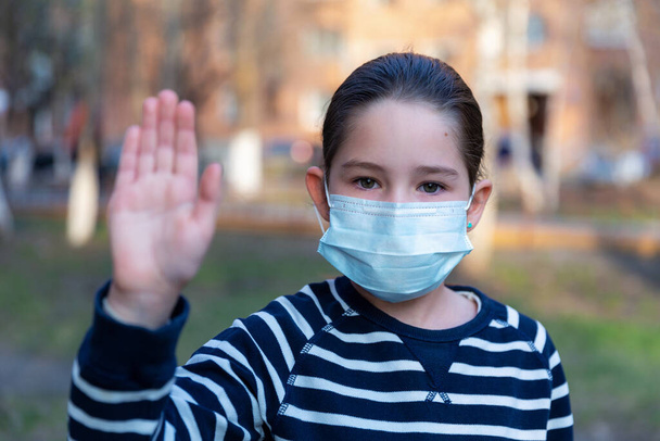 Coronavirus protection. A caucasian girl wearing protective mask - Фото, зображення