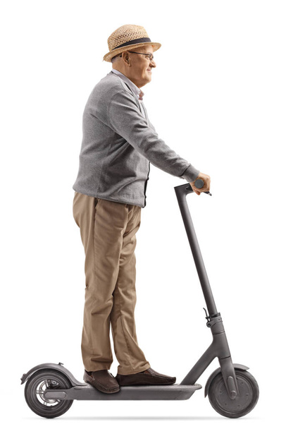 Elderly man riding an electric scooter isolated on white background - Foto, imagen