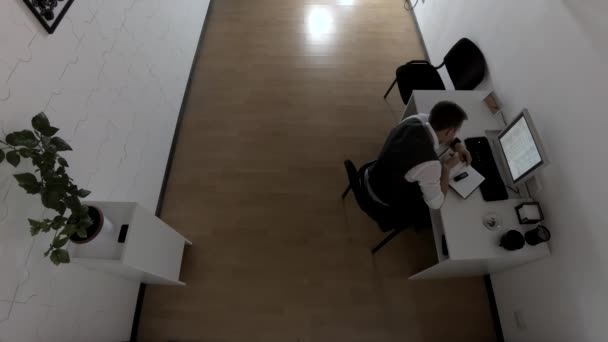 A nyomozó az irodájában ül az asztalnál, befejezi a munkáját és elmegy. - Felvétel, videó
