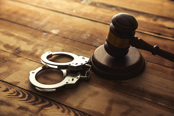 The judge gavel and handcuffs on tabl - Φωτογραφία, εικόνα