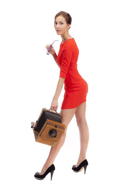 Girl in red dress with an old camera - Zdjęcie, obraz