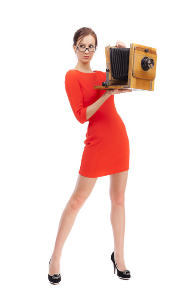 Girl in red dress with an old camera - Zdjęcie, obraz