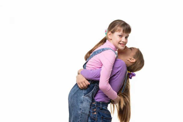 Girl lifted and hugged another a girl - Фото, изображение