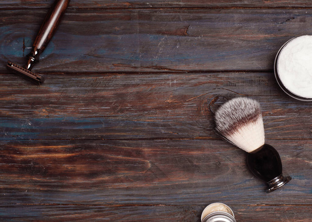 Razors, brush, and balsam on a wood background. - Valokuva, kuva