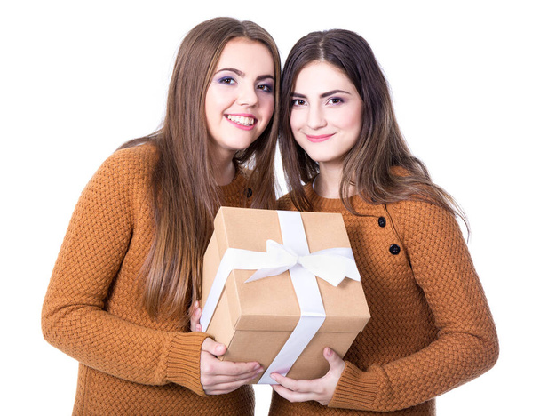 holidays and friendship - girls with gift box isolated on white background - Fotografie, Obrázek