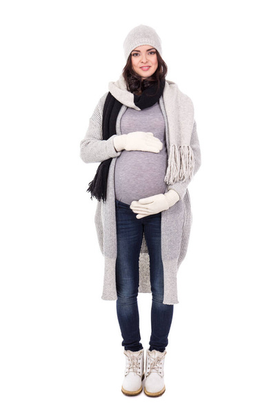 full length portrait of pregnant woman in winter clothes isolated on white background - Fotó, kép