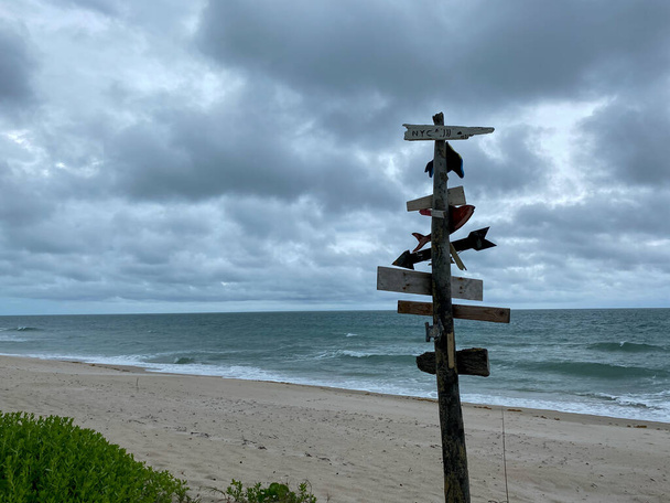 A city directional sign at a beach showing how far cities are from this point on a beach on North Hutchinson Island, Florida. - Photo, Image