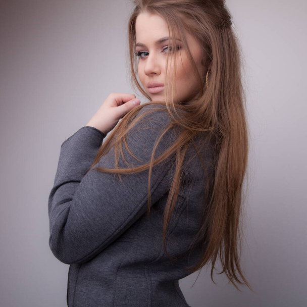 Young beautiful stylish girl posing in studio. - Foto, afbeelding