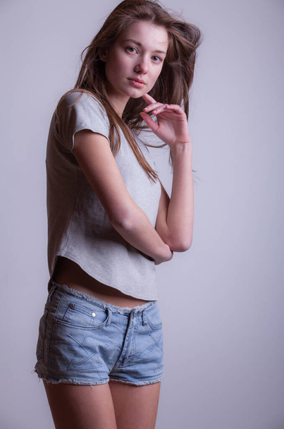 Young beautiful stylish girl posing in studio. - Fotó, kép