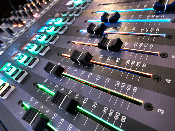 Angled perspective on volume faders on a digital soundboard for a church - Photo, Image