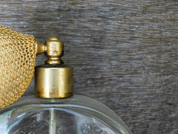 Close up view of a vintage perfume bottle top with diffuser atomizer pump, to left of frame - Photo, Image