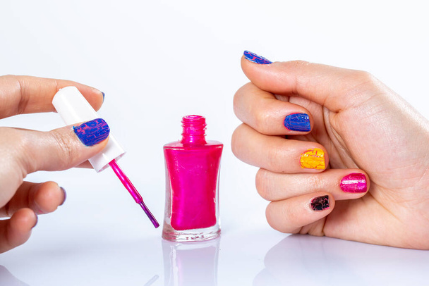 Hands with manicure and nail polish bottle.  - Photo, Image