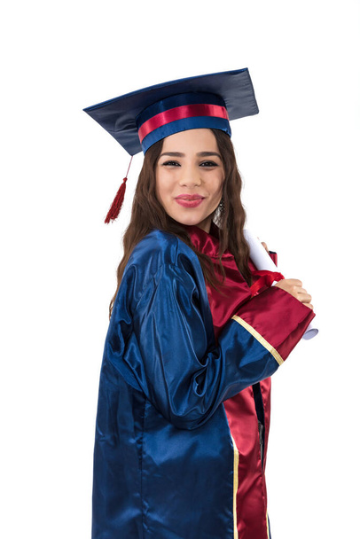 happy woman graduate student wearing graduation hat and gown, isolated on white background  - Photo, Image
