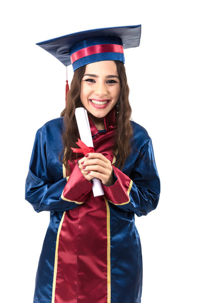 happy woman graduate student wearing graduation hat and gown, isolated on white background  - Фото, изображение