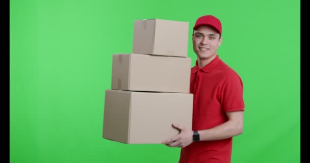 Courier in red uniform walking with parcels - Metraje, vídeo