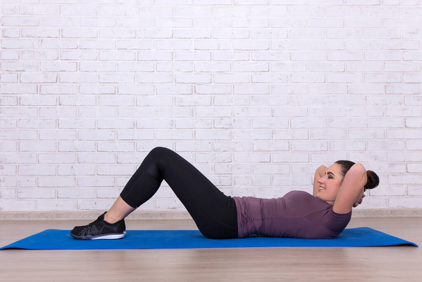 woman doing exercises for abdominal muscles at home - Photo, Image