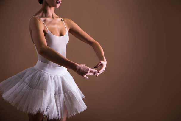 close up of young beautiful woman ballet dancer in tutu over beige background - Foto, imagen