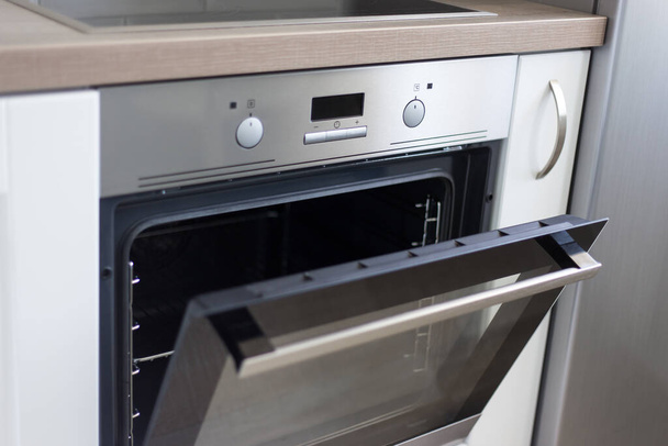 close up of electric stove with open door in modern kitchen - Photo, Image