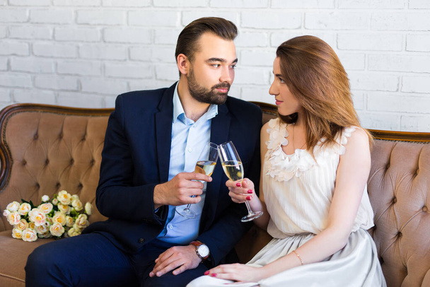 portrait of young beautiful couple celebrating something with champagne at home - Фото, зображення