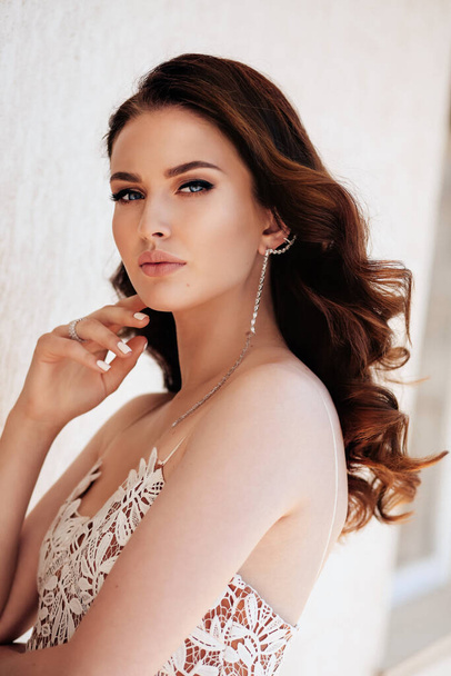 fashion studio photo of beautiful woman with dark hair in luxurious dress with jewelry - Zdjęcie, obraz