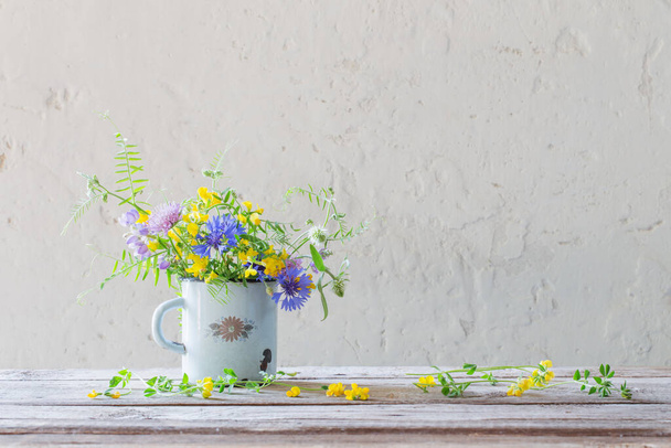 summer flowers in old cup on white background - Foto, Imagen