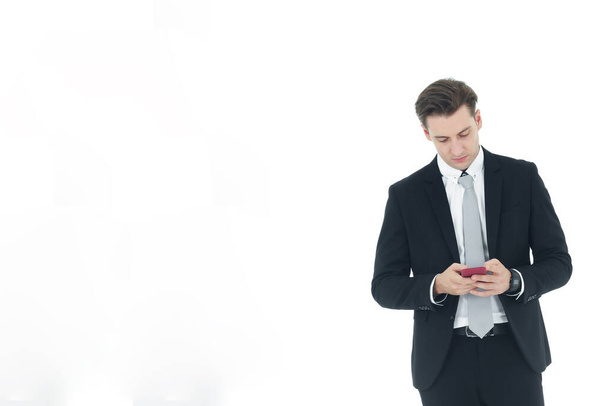 Bonito homem de negócios em um terno mão segurando smartphone isolado no fundo branco.Espaço de cópia
 - Foto, Imagem