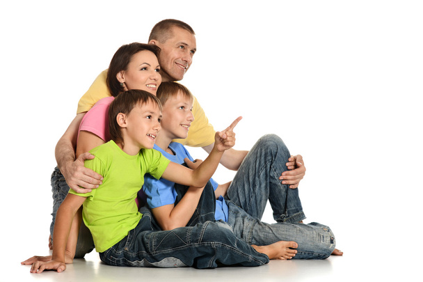 Frendly family on the floor on white background - Фото, зображення