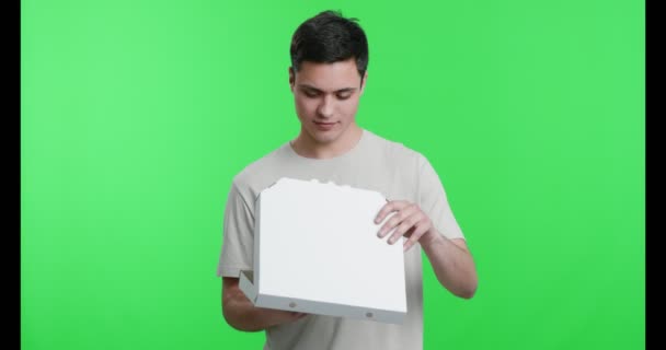 Young guy ready to eat pizza, smelling appetizing fast food - Filmmaterial, Video