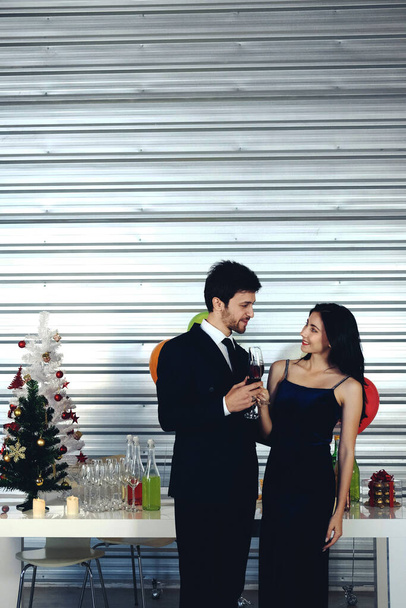 Сладкая пара Любовь улыбка и провести романтический с питьевой вино в рождественское время и празднование Нового года, День Святого Валентина с красочным воздушным шаром и подарочные коробки в кладовой области - Фото, изображение