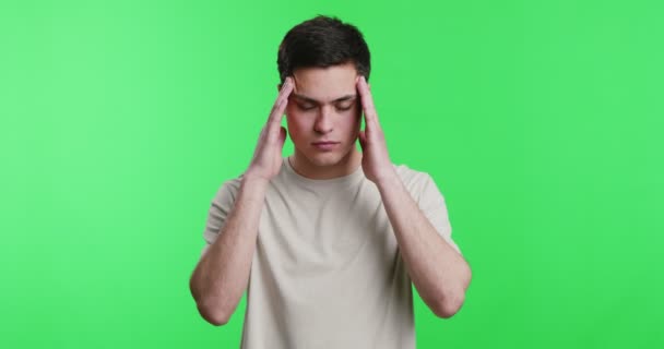 Young man with headache massaging his temples - Footage, Video