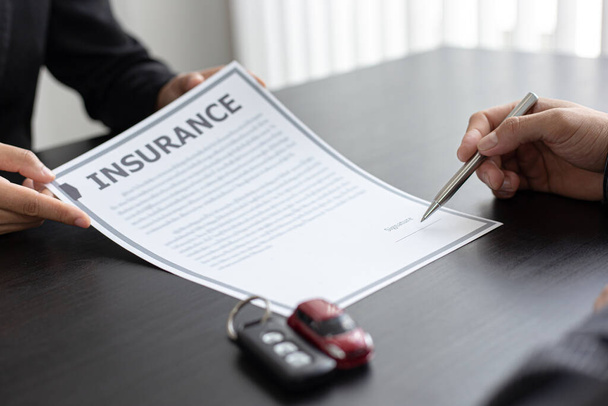 Autohändler oder Manager erlauben es Kunden, Dokumente und Kaufverträge mit Versicherungen zu unterzeichnen. Dokumentenunterzeichnung und Kreditzusage - Foto, Bild
